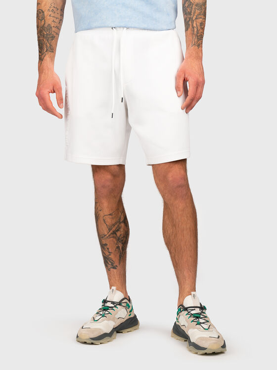 Beige shorts with embossed logo - 1