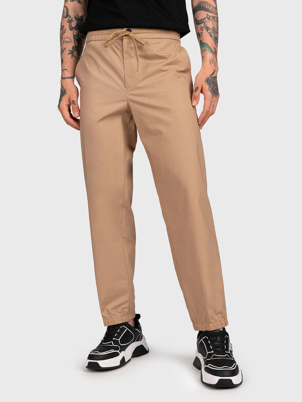 Beige trousers with logo patch - 1