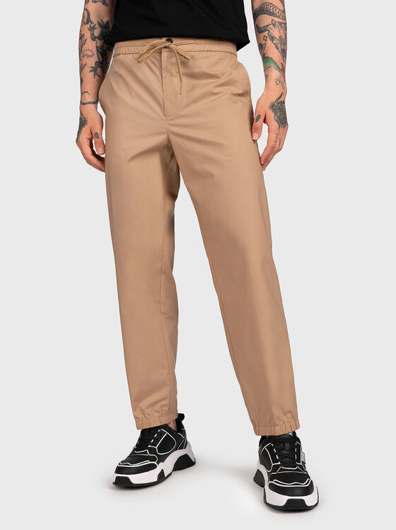 Beige trousers with logo patch - 1