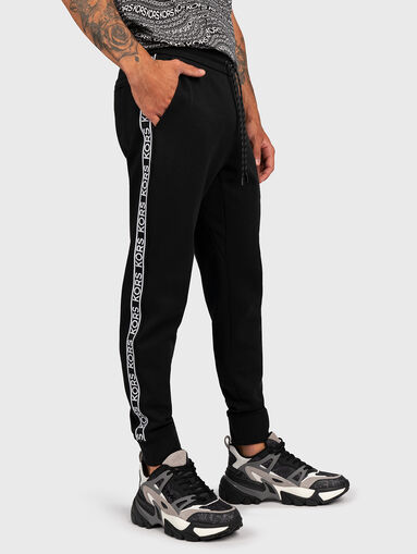 Sports trousers with logo stripe - 4