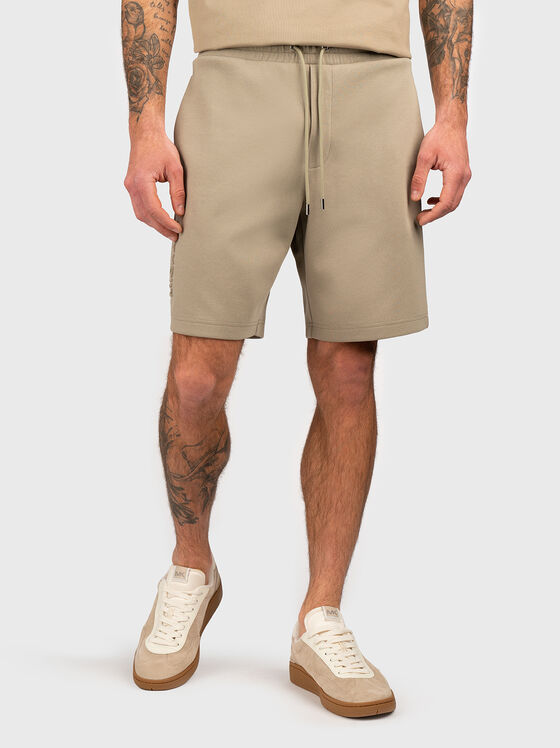 Beige shorts with embossed logo - 1